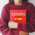 ESPANOLと書かれた本を抱える人の画像